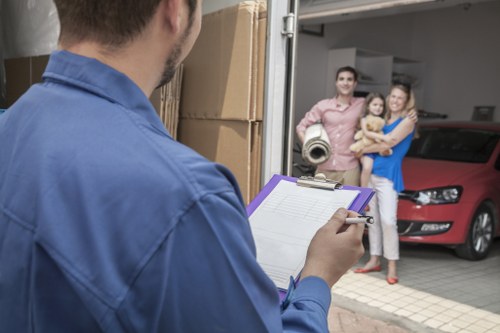 Moving crew navigating narrow access in a Soho residential building