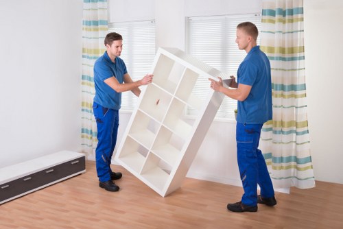 Professional movers handling household items in a Soho apartment building